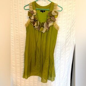 Green silk babydoll dress with floral trim at the neck